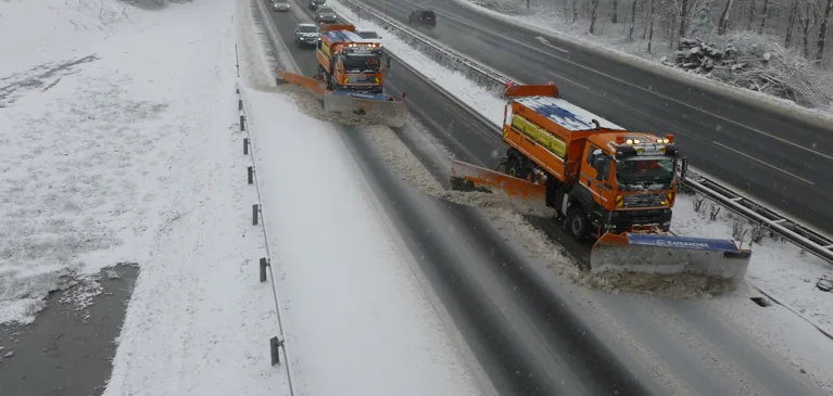 Schneepflüge fahren über die Autobahn